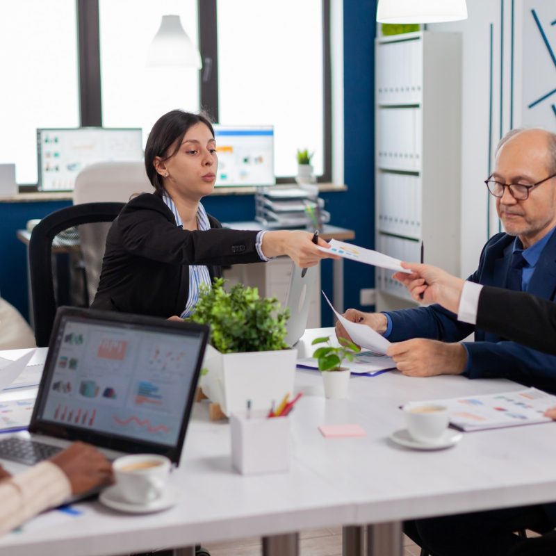 Group of diverse business people having a meeting in conference room. Businesswoman discussing ideas with colleagues about financial strategy for new start up company.